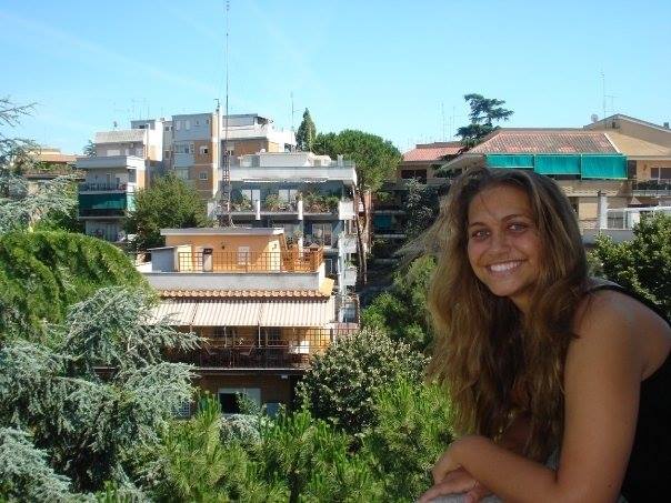 Girl leaning over a balcony