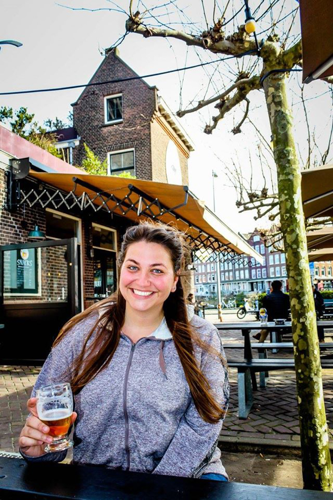 Girl drinking a beer in Amsterdam