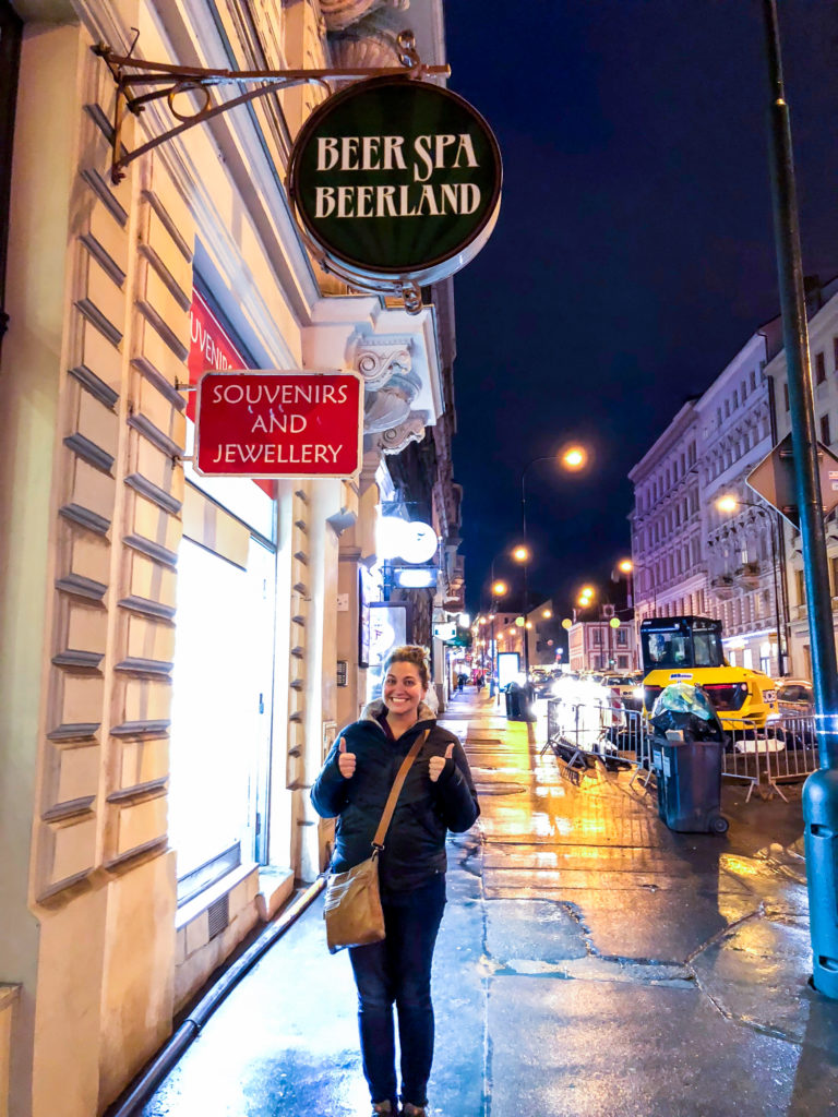 Girl standing in front of a beer spa in Prague