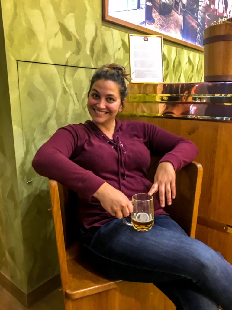 Girl sitting drinking a beer in a beer spa prague