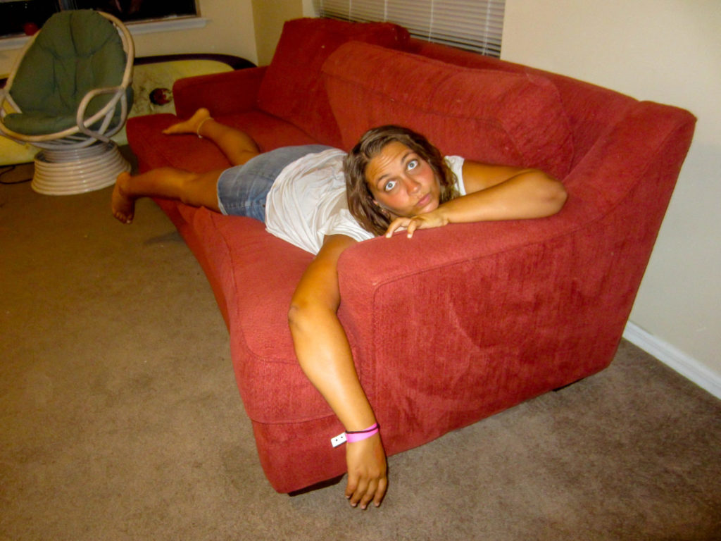 Girl laying on a red couch