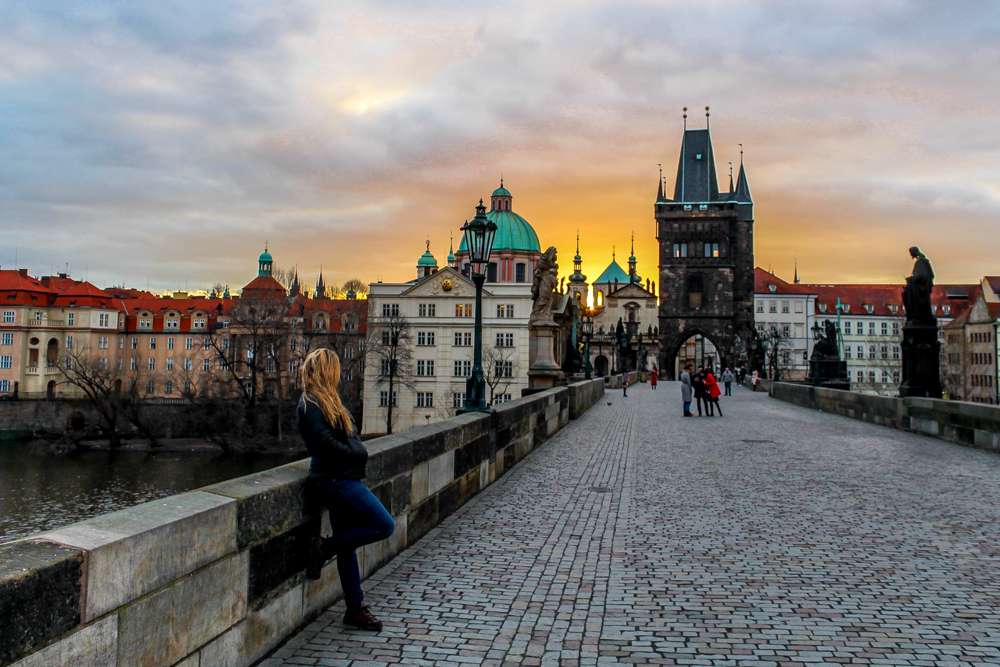 Girl during sunrise on Charles Bridge