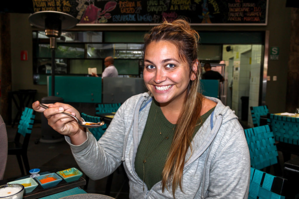 Girl eating ceviche in Peru