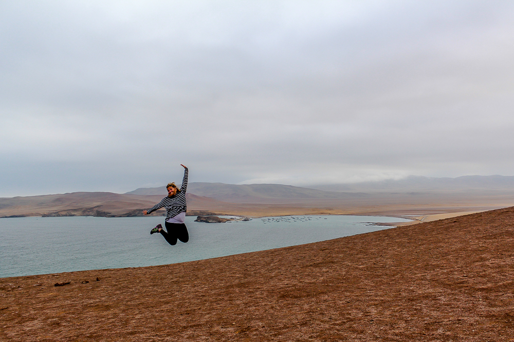 Girl jumping in a desert in Peru