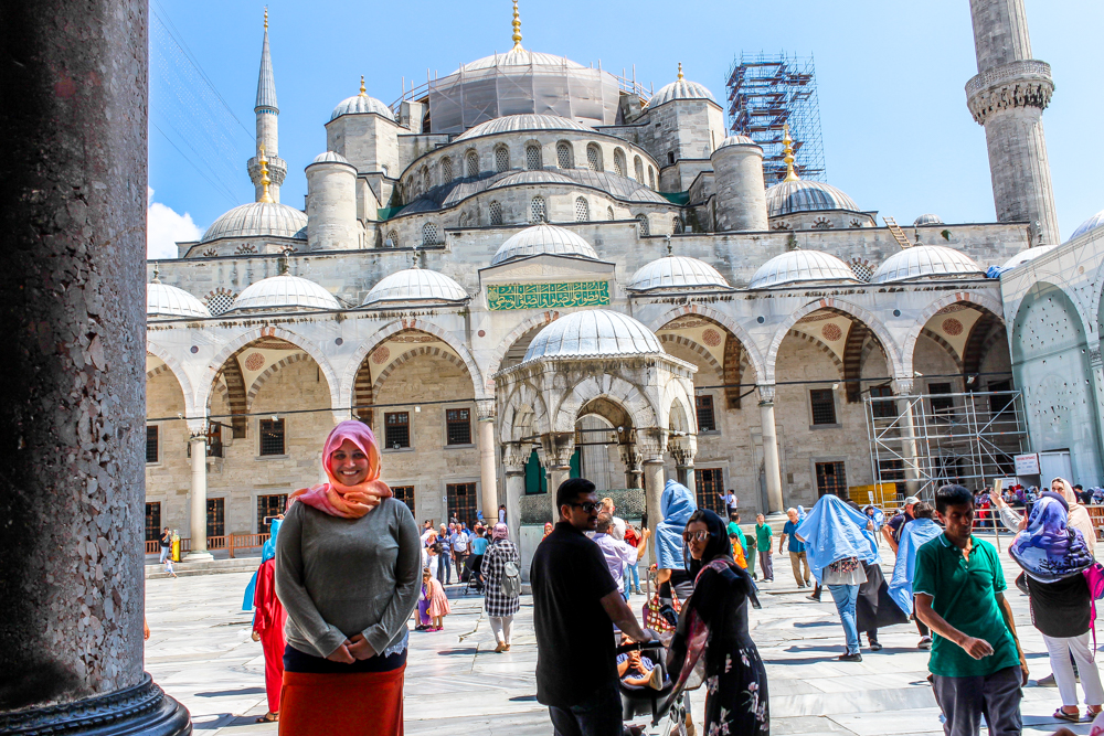 Overweight and traveling girl in front of a mosque in Istanbul