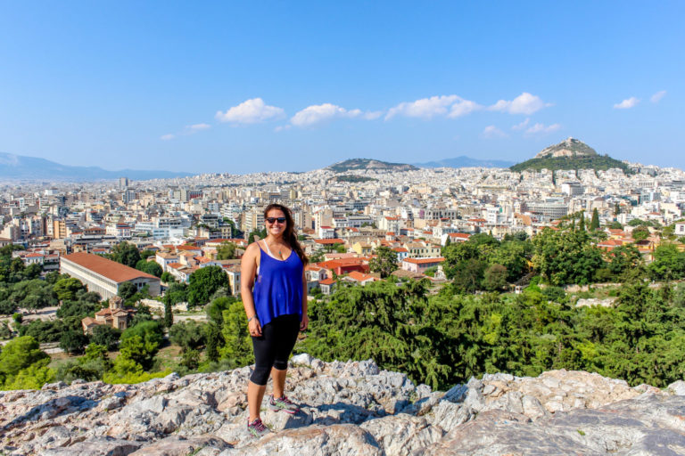 10 Most Asked Questions About Solo Travel Girl standing with an overview of Athens