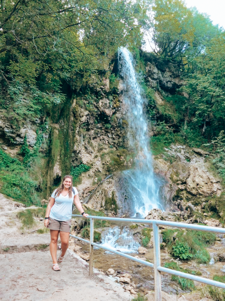 girl by a waterfall in serbia